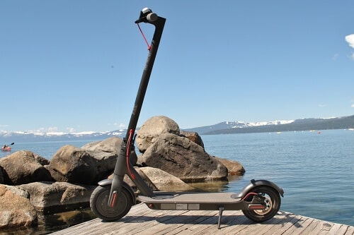 Xiaomi Mi M365 electric scooter on dock of lake