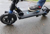 Close up of electric scooter deck with foot placed on it