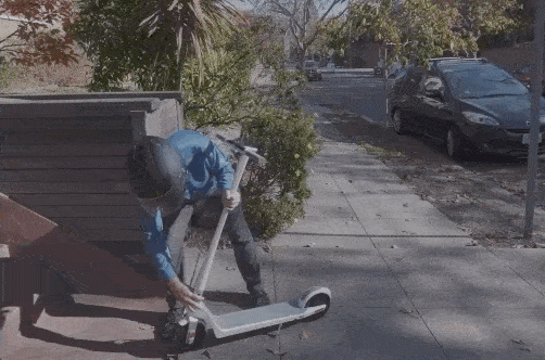 Man folding an electric scooter