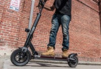 Man accelerating on the EVOLV Tour XL Plus electric scooter