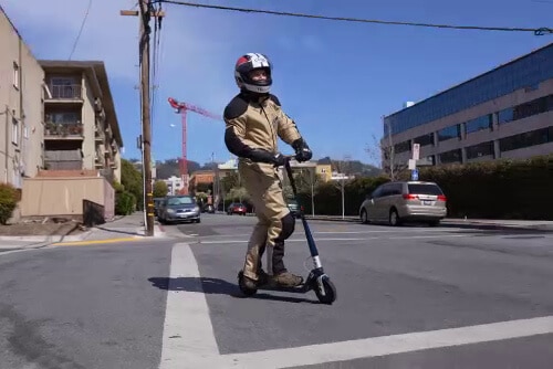 Man turning on an electric scooter