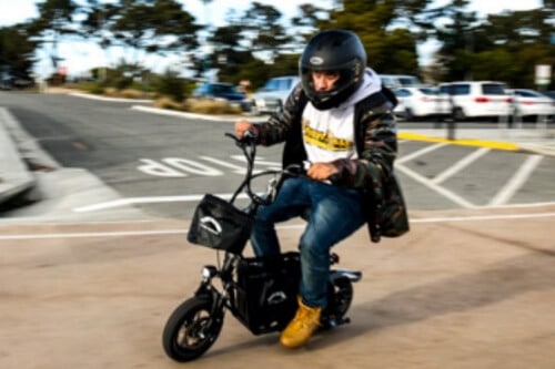 Fiido Q1S Electric Scooter - man riding on scooter, speed blur, full view