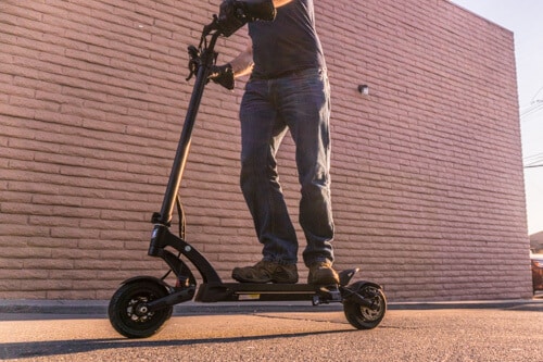 Kaabo Mantis 8 electric scooter with man riding, full scooter in view, low angle