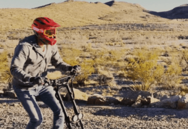 Alex Simon - Zero to Epic - man riding scooter in desert