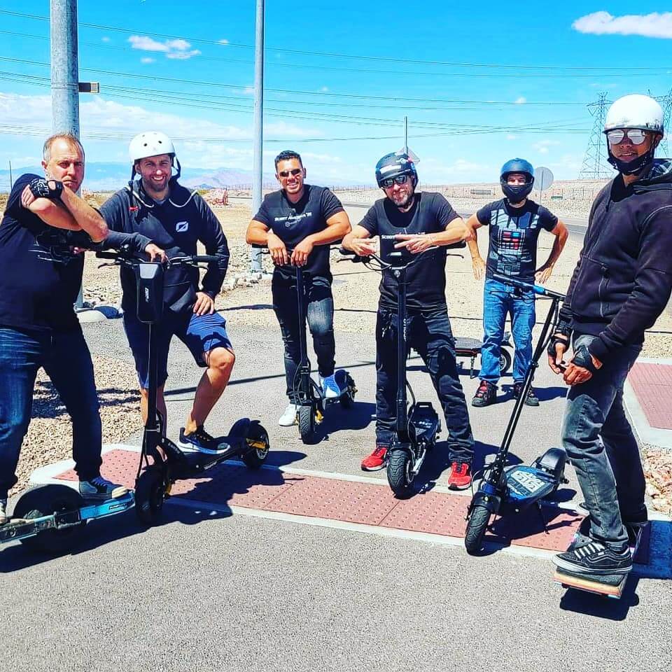 Scooter riders posing for a photo, 6 men