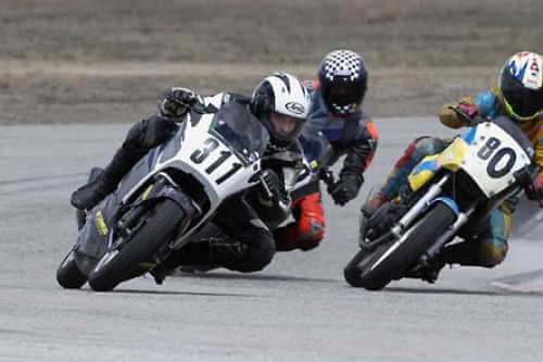 Motorcycle racers turning a corner closely together, action shot