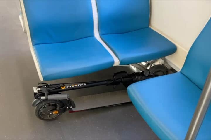 Electric scooter under a seat on a subway